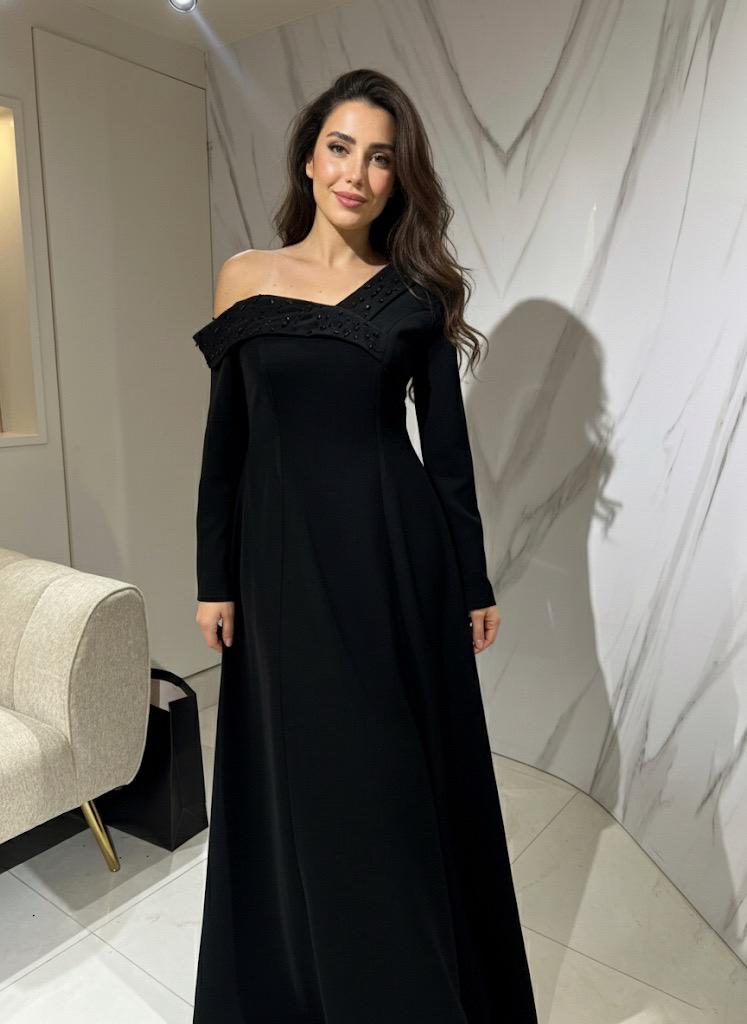 Black crêpe evening gown with a beaded off-shoulder neckline